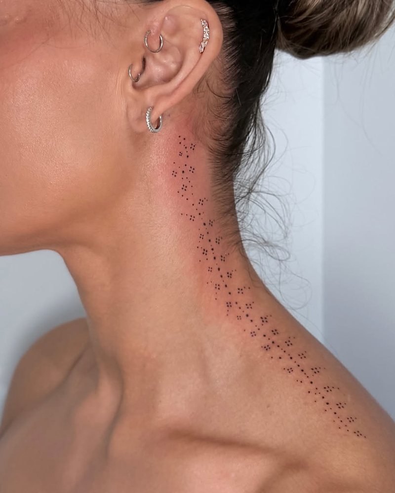 Fine dotwork running down the side of a neck